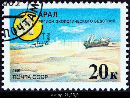 USSR - CIRCA 1991: A stamp printed in USSR from the 'Environmental Protection' issue shows Saiga antelope and dried bed of Aral Sea, circa 1991. Stock Photo