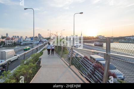 Bangkok / Thailand - December 30 2021: People relax at Chao Phraya Sky Park, Chao Phraya River close to Phra Pokklao Bridge in, Thonburi, Bangkok, Tha Stock Photo