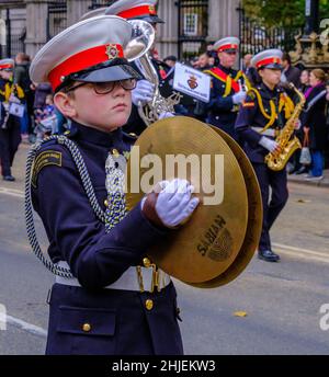 Young boy plays cymbals marching with the Surbiton Rbl Youth Marching Band at the Lord Mayor’s Show 2021, Victoria Embankment, London. Stock Photo