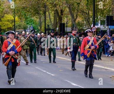 Reenactors dressed in British Redcoat & Battle of Waterloo uniforms march in the Lord Mayor’s show 2021, Victoria Embankment, London. Stock Photo