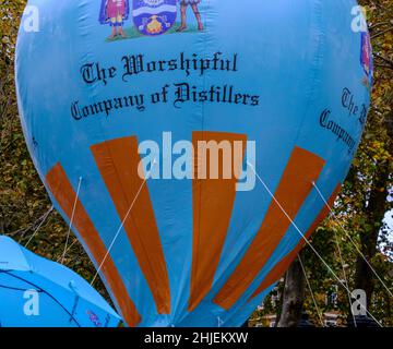 Large blue hot air balloon with The Worshipful Company of Distillers on it at the Lord Mayor’s show 2021, Victoria Embankment, London, UK Stock Photo