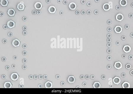Frame made with metal hexagon nuts on gray background. Abstract border. Top view Flat lay Copy space. Stock Photo