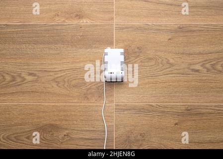 A carbon dioxide and gas sensor installed in a domestic boiler room on the wall, powered with 230 volts. Stock Photo