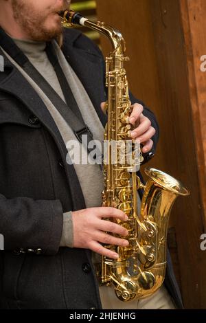 Crop man playing saxophone on street Stock Photo