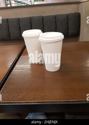 Side view of empty disposable takeaway coffee cup on a table Stock Photo