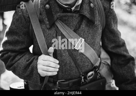 Man Re-enactor Dressed As World War II Soviet Russian Red Army Officer Soldier. Russian Overcoat Uniform In WWII WW2 Times. Photo In Black And White Stock Photo