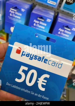 Germany, Viersen - January 9. 2022: Closeup of online payment voucher card of paysafe in shelf of german supermarket (selective focus on letter f in w Stock Photo