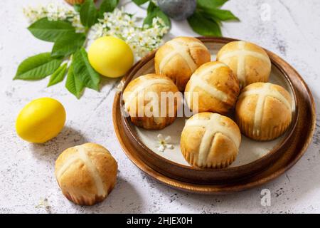 Easter baking. Homemade Easter traditional hot cross buns on a gray stone tabletop. Stock Photo