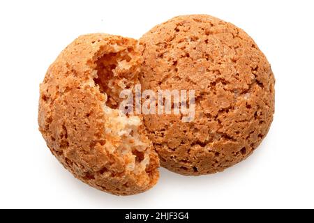 One whole and one broken amaretti biscuits isolated on white. Top view. Stock Photo