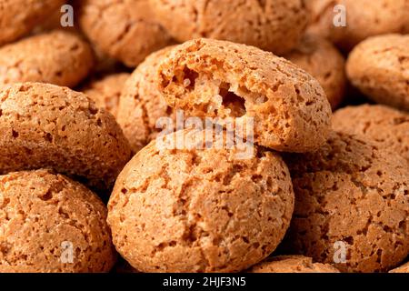 Background of amaretti biscuits. One broken Stock Photo