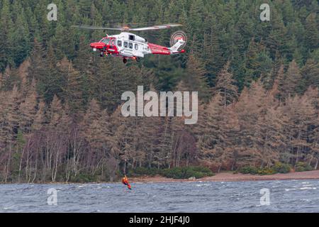 Inverness Coastguard Helicopter practicing winching at Loch Ness Stock Photo