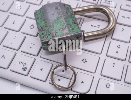 Lock lies on a computer keyboard Stock Photo