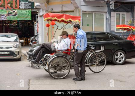 Bicycle rickshaw (cyclo or pedicab) in the streets of the Old Quarter of Hanoi, Vietnam, Southeast Asia Stock Photo