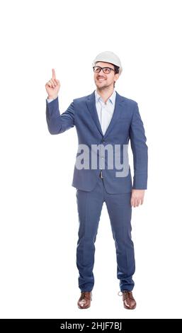 Full length positive engineer wearing protective helmet, confident pointing up his forefinger isolated on white background Stock Photo