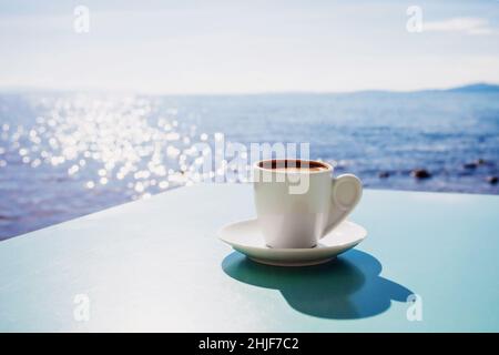 Greek coffee at table over a sea at background, Greece Stock Photo