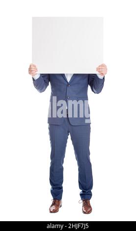 Anonymous businessman covering head with a blank banner, like a mask to hide emotions. Full length incognito person with hidden face isolated on white Stock Photo