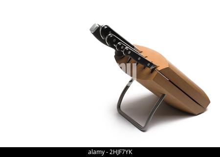 Close up of high quality wooden knife block with metal stand and different size knives and sharpening stick in white background Stock Photo