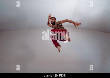 Muscular dance performer practicing dance moves at the studio Stock Photo