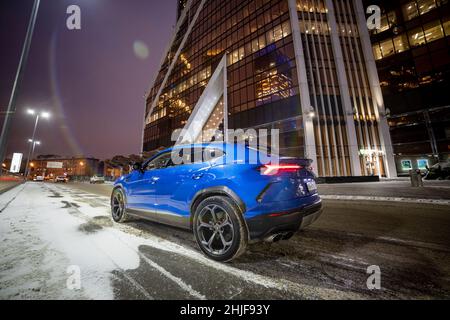 Moscow, russia - December 13, 2020: premium crossover lamborghini urus stand city road in night downtown city Stock Photo