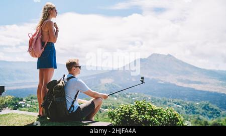 Unrecognizable tourists taking picture on viewpoint Stock Photo