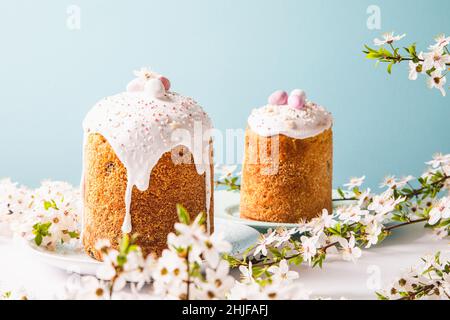 Easter cake with glace icing and decoration. Postcard with Easter bread. Christian traditions. Copy space. White background Stock Photo