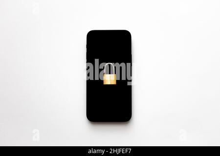An isolated black smartphone with a small padlock on it on white background. Phone protection idea. Online data privacy protection concept. Stock Photo