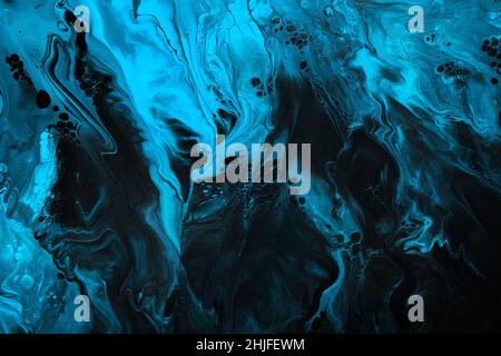 Fluid Art. Blue abstract wave swirls on black background. Marble effect background or texture. Stock Photo