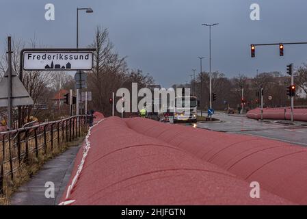 Big pink water tube to prevent the storm Malik in Frederikssund to flood the city Fredrikssund, Denmark, January 29, 2022 Stock Photo