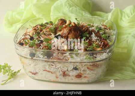 Ghee rice and chicken roast. A rice dish made of basmati rice, ghee, spices and garnished with fried onions, cashews and raisins. Served with kerala s Stock Photo