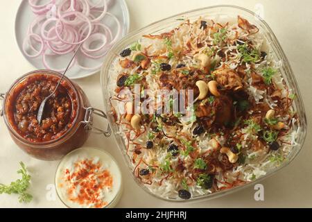 Ghee rice and chicken roast. A rice dish made of basmati rice, ghee, spices and garnished with fried onions, cashews and raisins. Served with kerala s Stock Photo