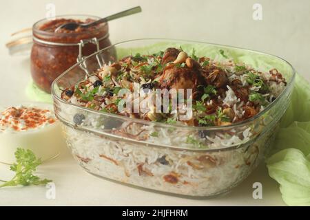 Ghee rice and chicken roast. A rice dish made of basmati rice, ghee, spices and garnished with fried onions, cashews and raisins. Served with kerala s Stock Photo