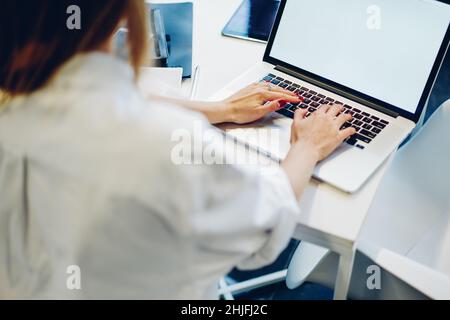 Unrecognizable remote worker using computer at workplace Stock Photo