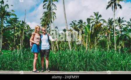Joyful couple taking selfie in tropical park Stock Photo