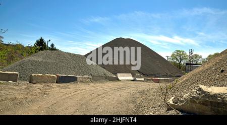 Large industrial mound of gravel,sand,asphalt and macadam or road pavement and broken stone. Stock Photo