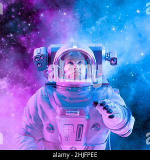 Peaceful female astronaut - 3D illustration of woman in space suit inside softly glowing pink and blue galactic cloud Stock Photo
