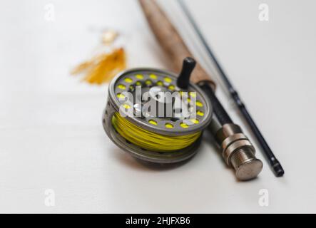 Fishing rod and reel on a yellow background. Casting rod with a multiplier  reel. Fishing tackle. Selective focus Stock Photo - Alamy