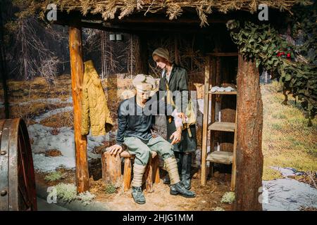 Nurse Tape Up The Arm Of The Partisan In The Forest In The Belarusian Museum Of The Great Patriotic War In Minsk, Belarus Stock Photo