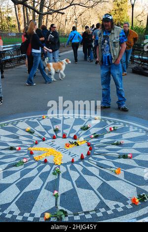 The Imagine mosaic is covered with flowers and strawberries at Strawberry Fields in Central Park, New York Stock Photo