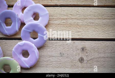 Party ring biscuits by FOX's set against a wooden background with copy space Stock Photo