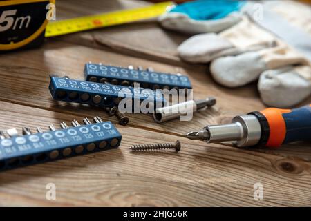 Screw drive. Adjustable torque screwdriver, work tool on wooden background. Hand tool on workshop table, closeup view Stock Photo