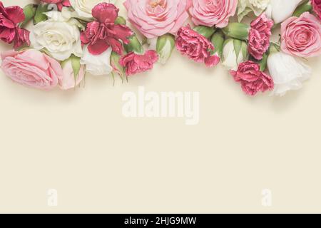Spring flowers arranged against the pastel yellow background. Valentine's day, wedding backdrop. Stock Photo