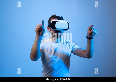 Modern architect, designer using virtual reality glasses at workplace. Designer working in augmented reality vr studio. Man working in VR goggles on a Stock Photo