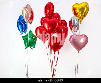 Foil balloon air balloons of heart shaped and stars. Love concept. Holiday and celebration. Valentine's Day or wedding, bachelorette party decoration. Stock Photo