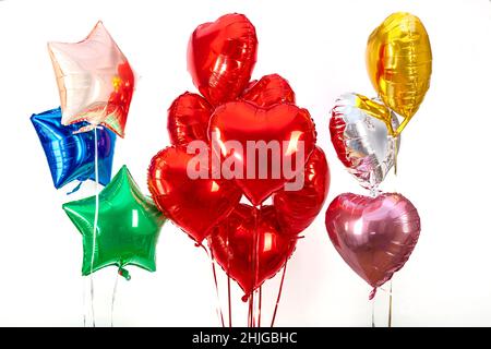 Foil balloon air balloons of heart shaped and stars. Love concept. Holiday and celebration. Valentine's Day or wedding, bachelorette party decoration. Stock Photo