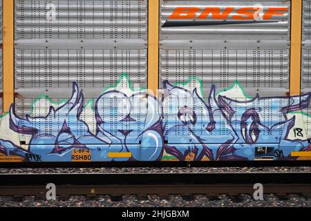 Graffiti painted on BNSF shipping container traveling on the Northern Transcon route that runs from Chicago to Seattle. Near Troy, Montana. Stock Photo