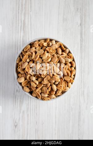 Roasted Salted Shelled Peanuts in a Gray Bowl, top view. Flat lay, overhead, from above. Stock Photo
