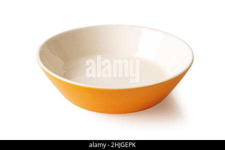 Empty porcelain bowl isolated on a white background. Orange beige ramekin close-up. Empty crockery for food design. Modern ceramics porcelain dishes. Stock Photo