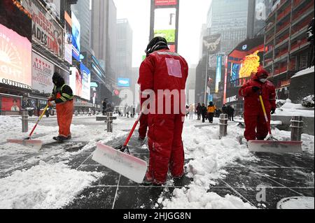 New York, USA. 29th Jan, 2022. Times Square Alliance maintenance workers shovel snow during a winter storm that brought more than 7 niches of snow and heavy wind gusts to the city, New York, NY, January 29, 2022. New York City is under a hazardous travel advisory as a Nor'easter knocks out power in the Northeast and brings heavy snow across the region. (Photo by Anthony Behar/Sipa USA) Credit: Sipa USA/Alamy Live News Stock Photo