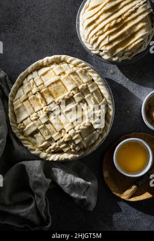Two pies with lattice crust on dark neutral background Stock Photo