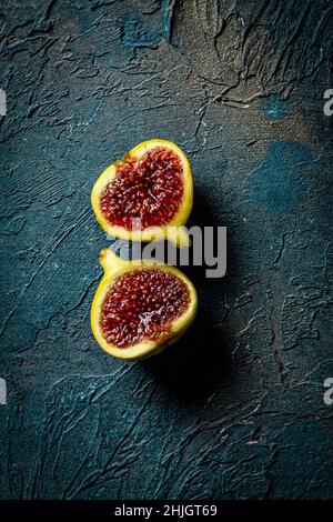 Figs Close Up, halved on a blue background Stock Photo